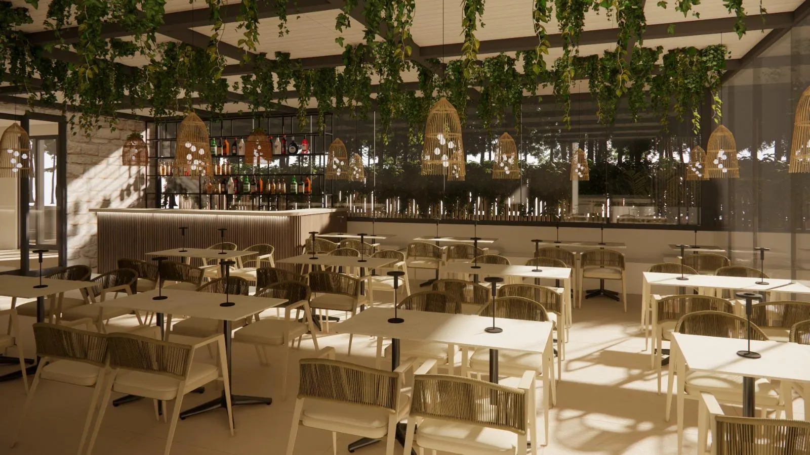 The restaurant with rows of tables, the bar behind, rattan lamps under a pergola hung with vines.